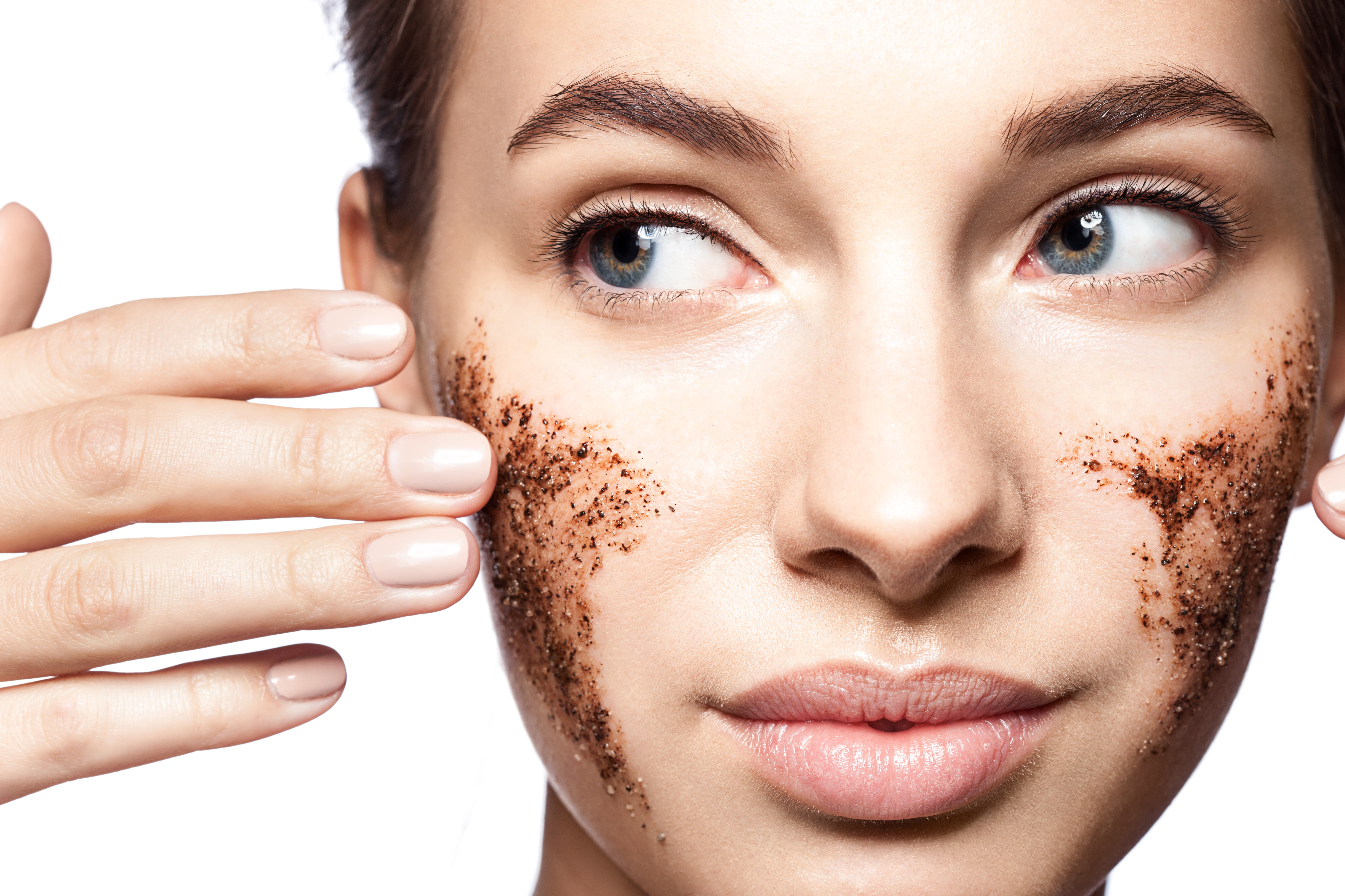 Close-up-portrait-of-a-beautiful-woman-with-a-coffee-scrub-on-her-face-doing-peeling-skin-isolated-on-white-background-825324532_5616x3744.jpeg